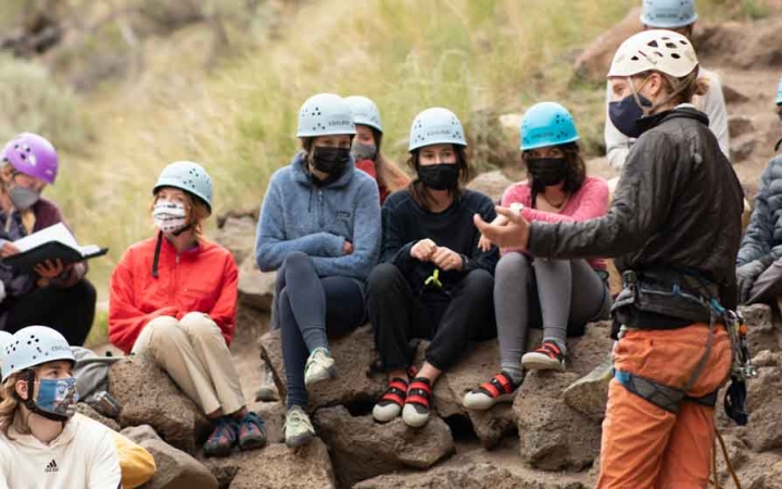 a group of students listen to an instructor on an outward bound course in oregon